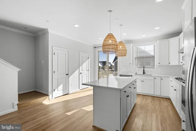 a kitchen with counter top space sink and cabinets