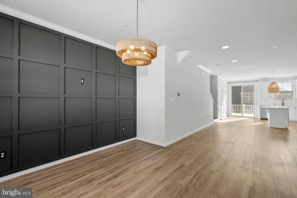 a view of a room with wooden floor and chandelier