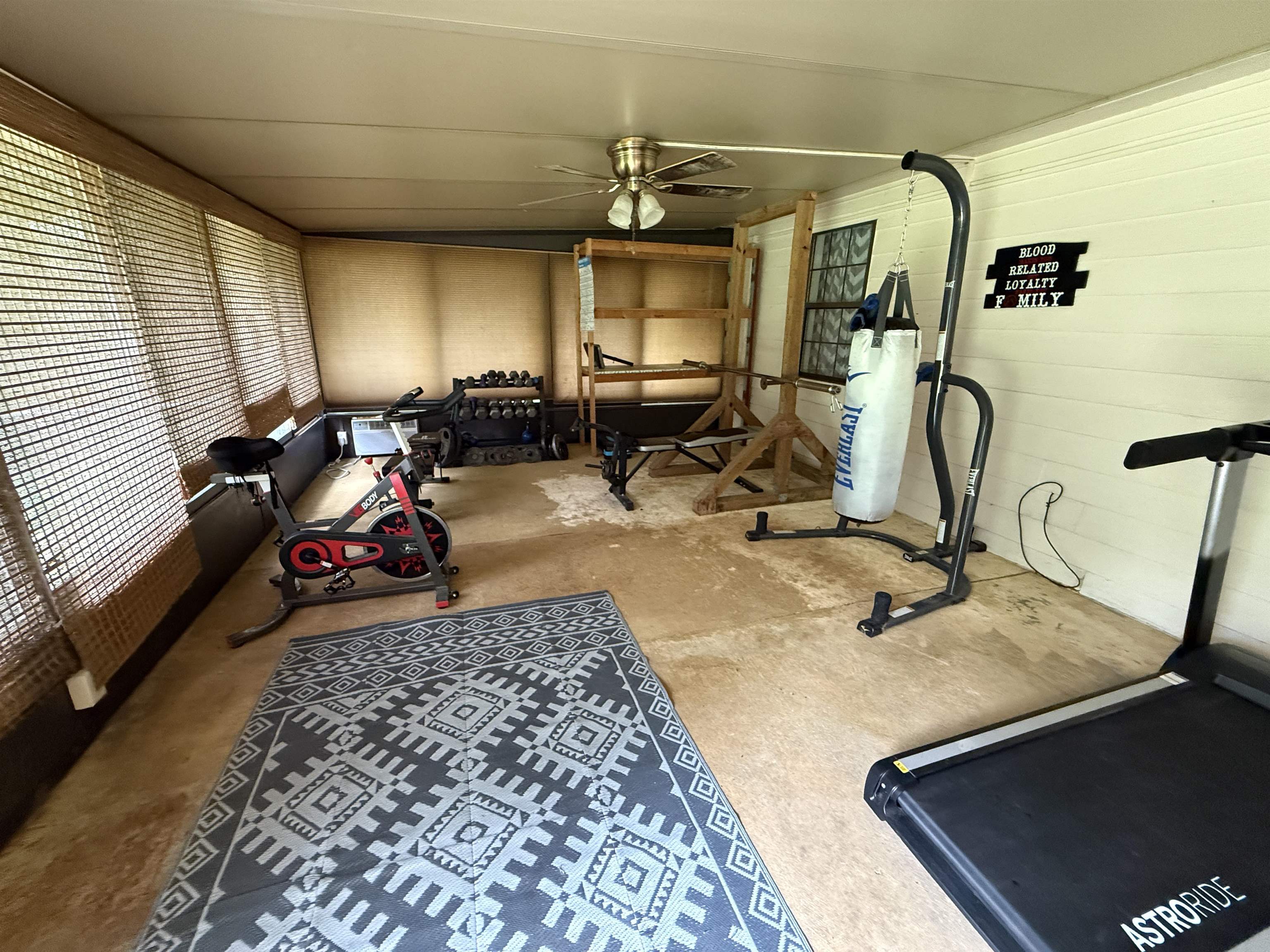 185 Mignon Road Atoka, TN 38004 - Photo 29 of 34 Enclosed patio area featuring multiple window blinds, a ceiling fan, and painted paneling