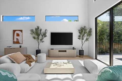 a very nice looking dining room with a large window and chandelier