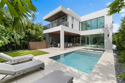 a view of a patio with table and chairs potted plants