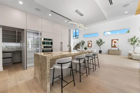 a large white bathroom with a large tub sink shower and mirror