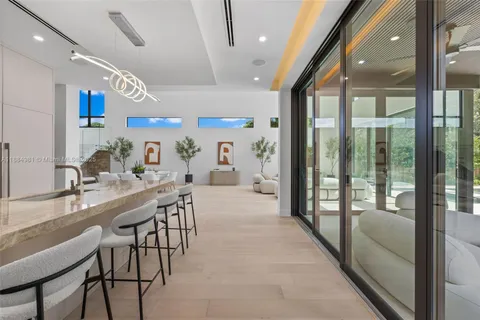 a large white bed sitting in a room next to a window