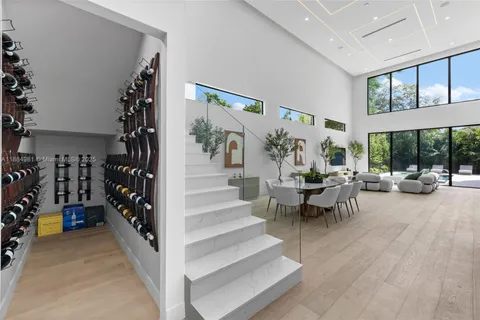 a bedroom with a large bed and chandelier