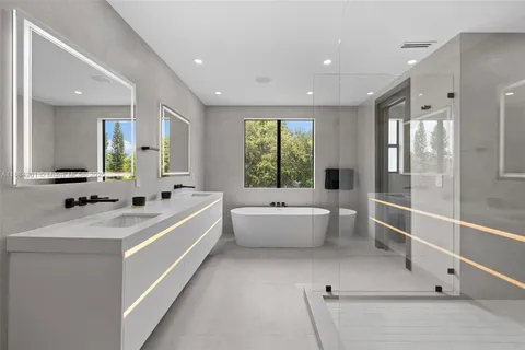 a bathroom with a granite countertop sink toilet and a mirror