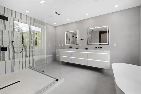 a bathroom with a granite countertop sink toilet a mirror and shower