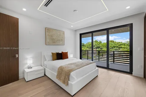 a view of a patio with table and chairs with wooden floor and fence