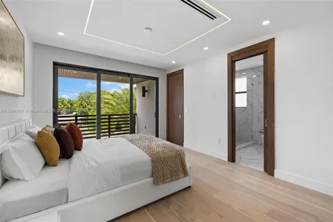 a kitchen with stainless steel appliances kitchen island granite countertop a table chairs and a barbeque