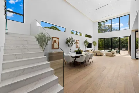 a dining room with furniture wooden floor and a potted plant