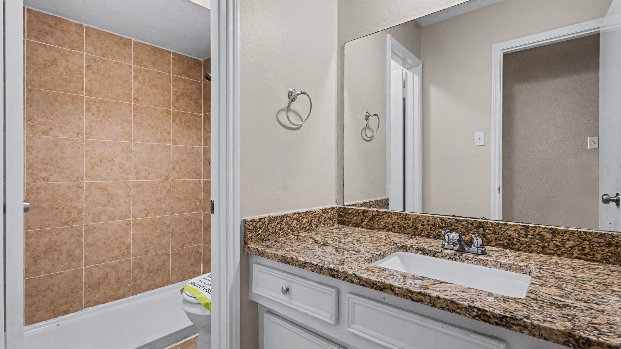 23210 Earlmist Drive Spring, TX 77373 - Photo 13 of 22 a bathroom with a granite countertop sink and a mirror