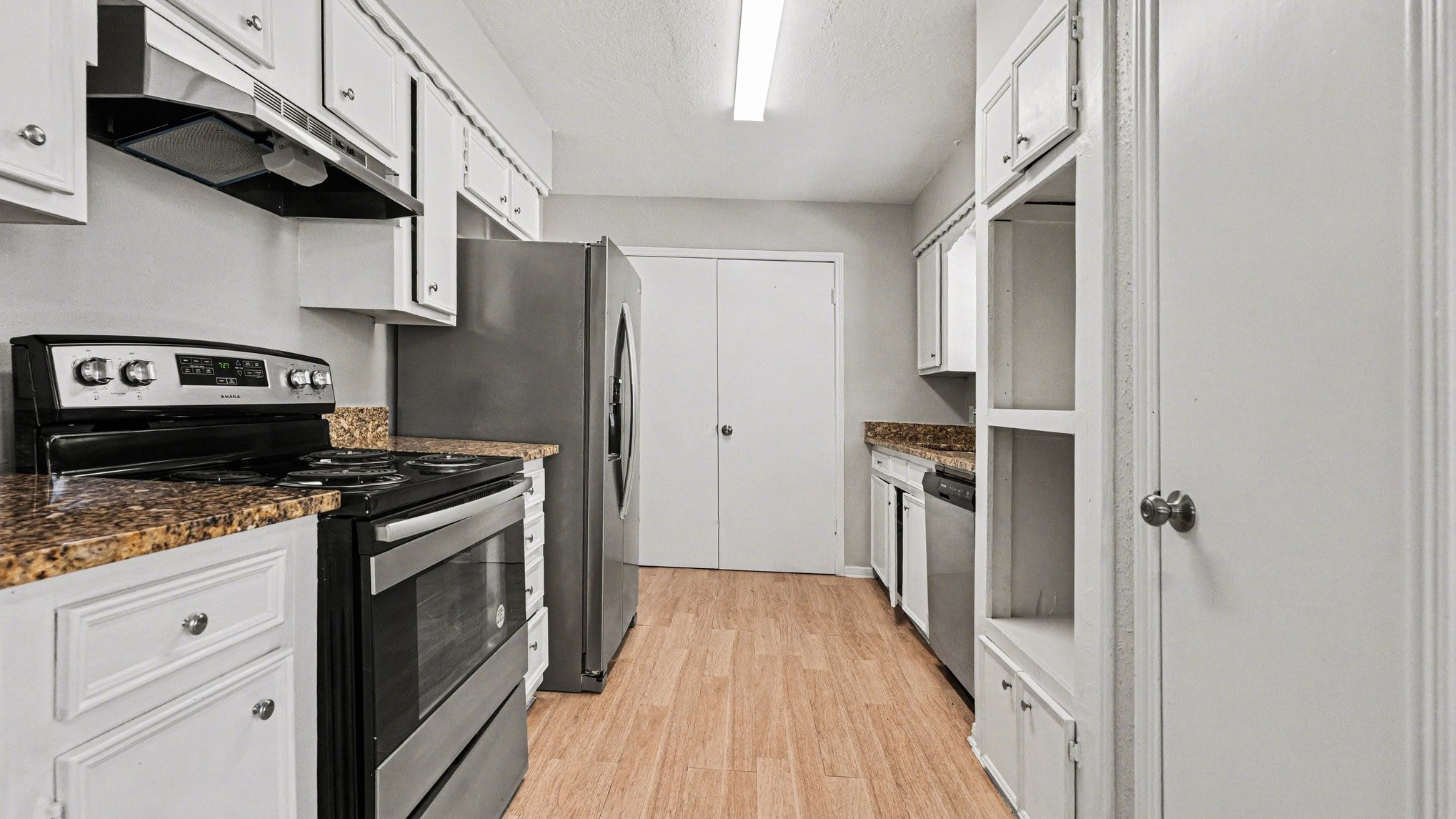 23210 Earlmist Drive Spring, TX 77373 - Photo 7 of 22 a kitchen with stainless steel appliances granite countertop a stove a refrigerator and a wooden cabinets