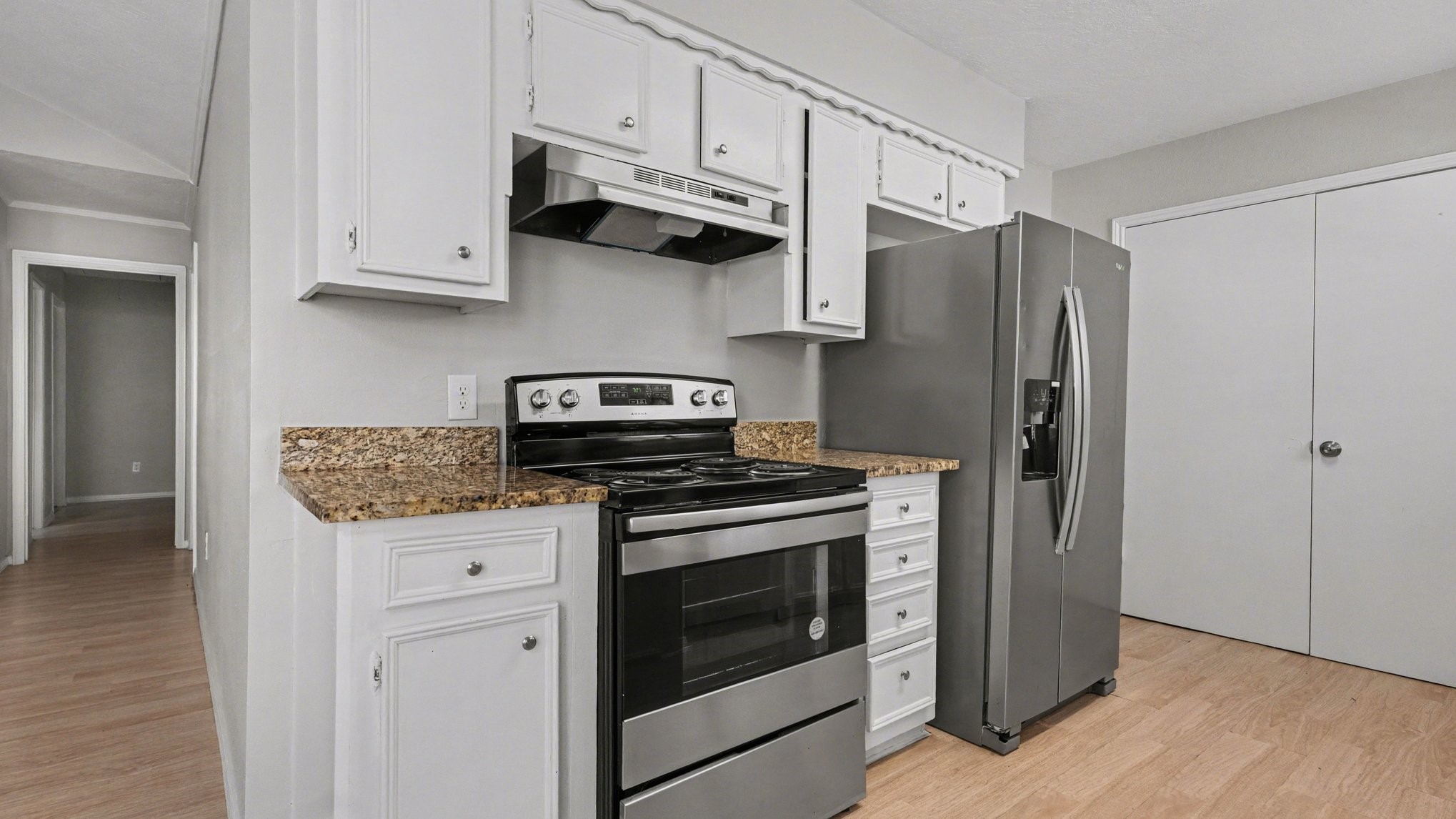 23210 Earlmist Drive Spring, TX 77373 - Photo 9 of 22 a kitchen with stainless steel appliances granite countertop a stove a refrigerator and a white cabinets