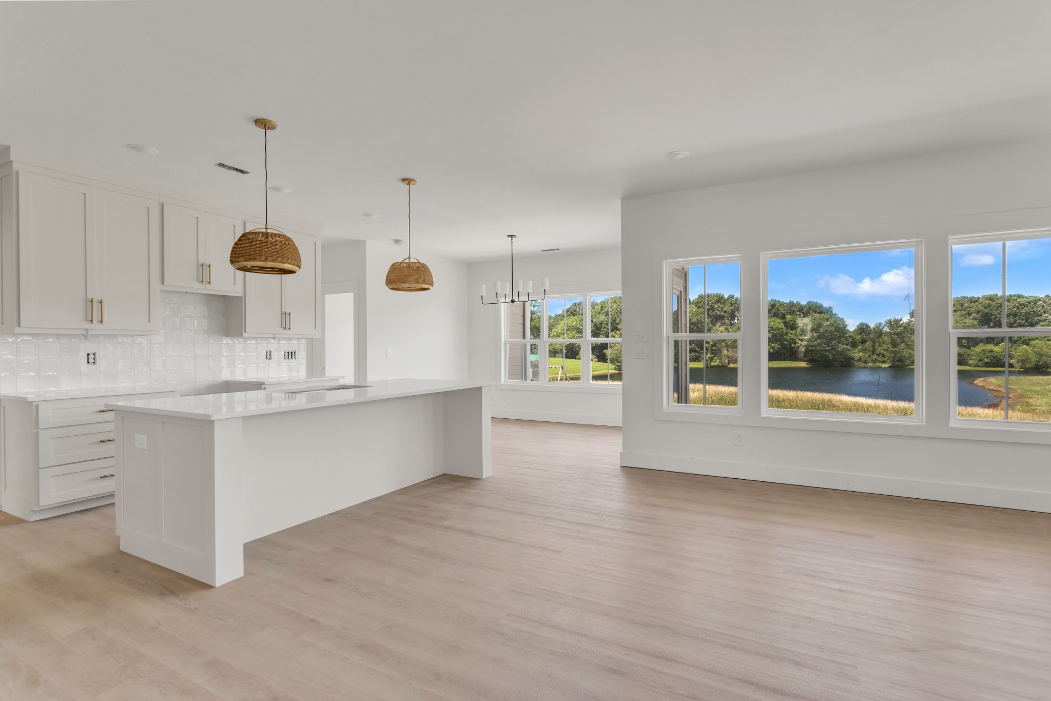 1171 Abiff Road Bon Aqua, TN 37025 - Photo 2 of 45 a large kitchen with kitchen island a sink wooden floor and a large window