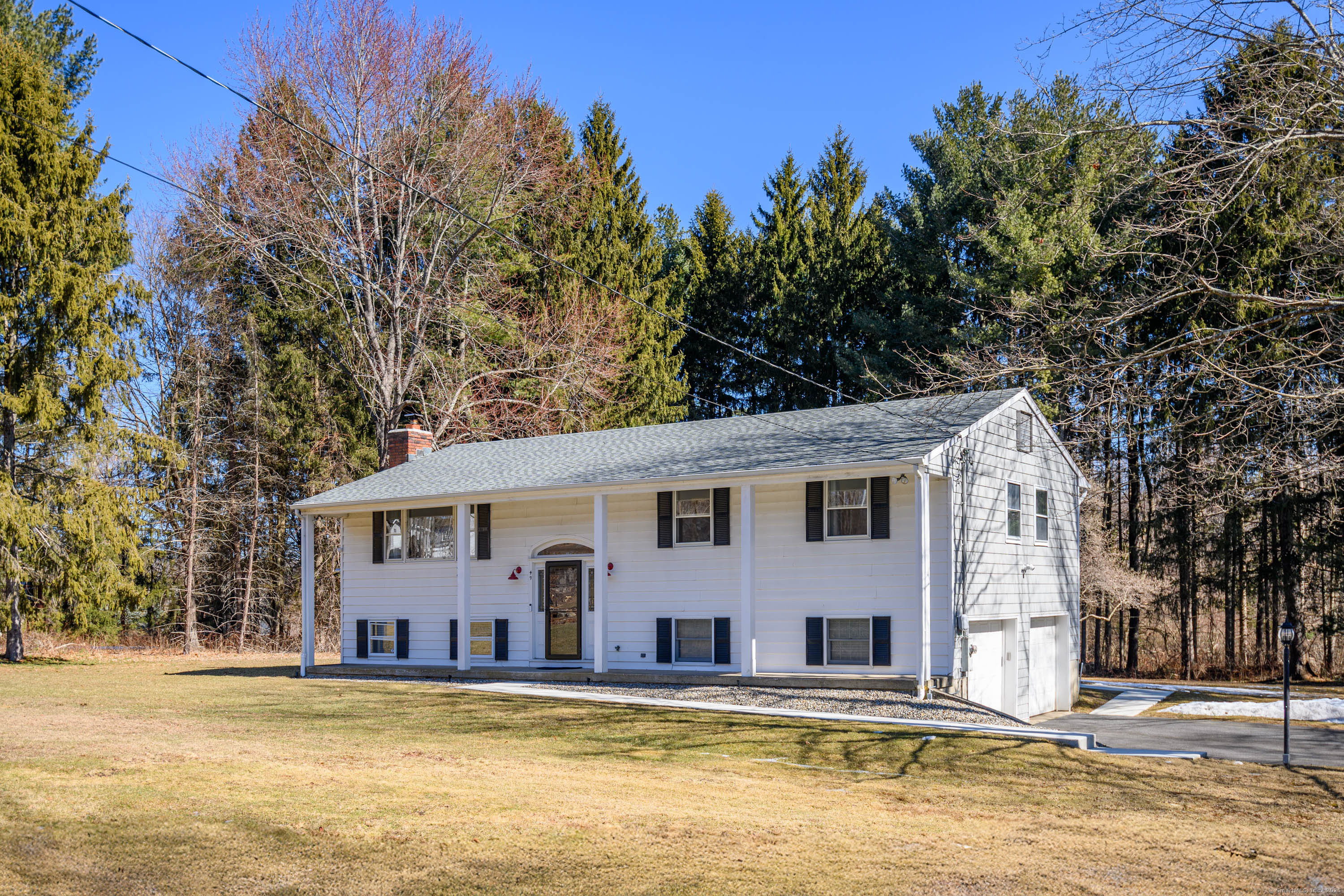 a view of a large white building with a large pool