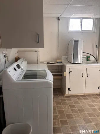 a bathroom with a sink a toilet and a window