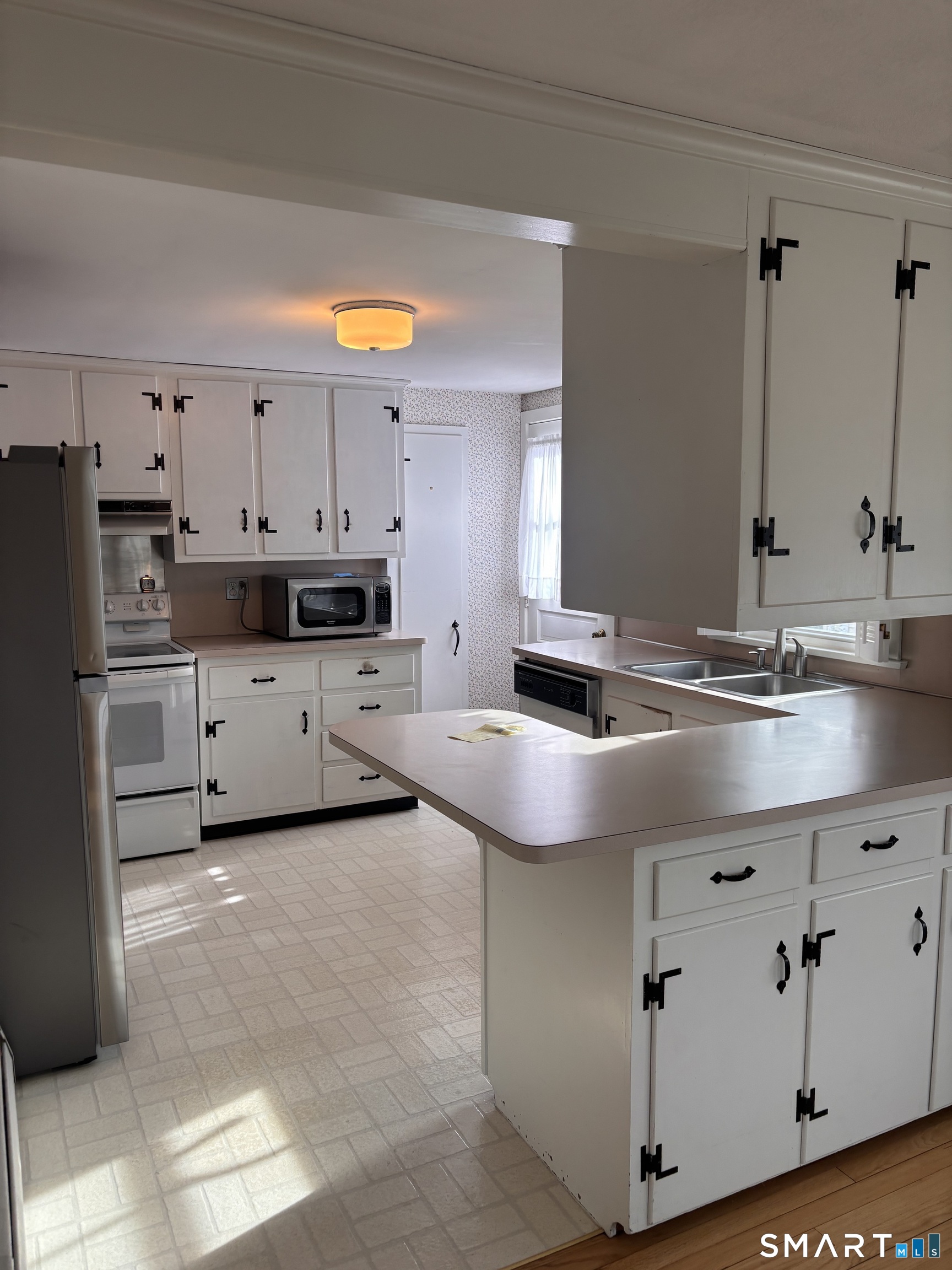 28 Bayberry Lane Groton, CT 06340 - Photo 5 of 17 a kitchen with stainless steel appliances granite countertop a sink and white cabinets