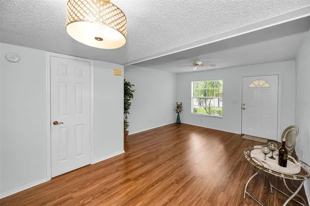 a kitchen with stainless steel appliances granite countertop white cabinets and chairs