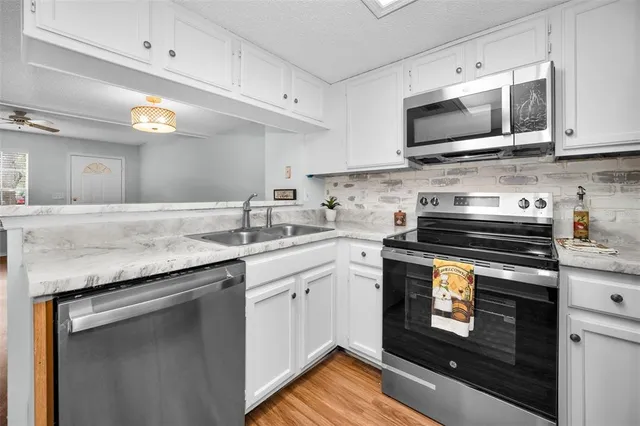 a kitchen with sink cabinets and wooden floor