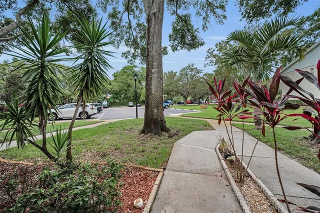 a view of swimming pool with seating area and trees