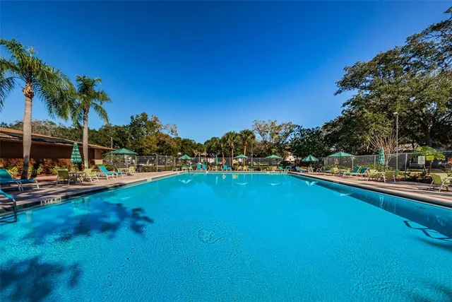 a swimming pool with outdoor seating and yard