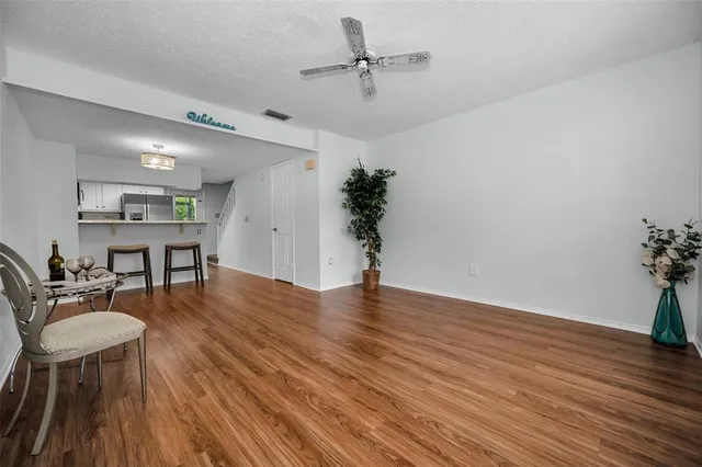 a view of a dining room with furniture and wooden floor