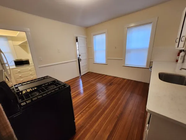 a kitchen with wooden floors and a stove