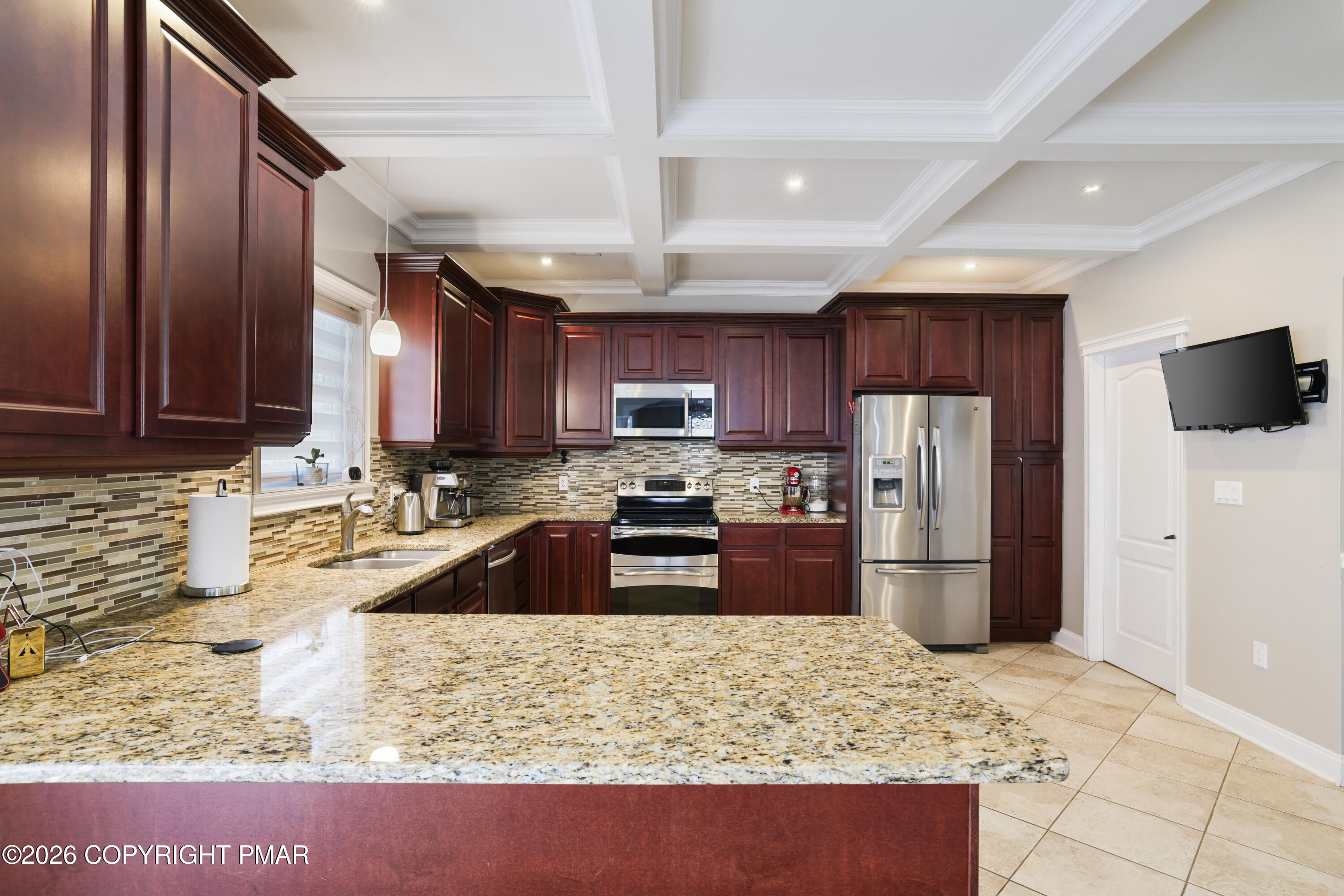 117 Fernwood Road Bushkill, PA 18324 - Photo 17 of 65 a kitchen with granite countertop wooden cabinets a refrigerator and a sink