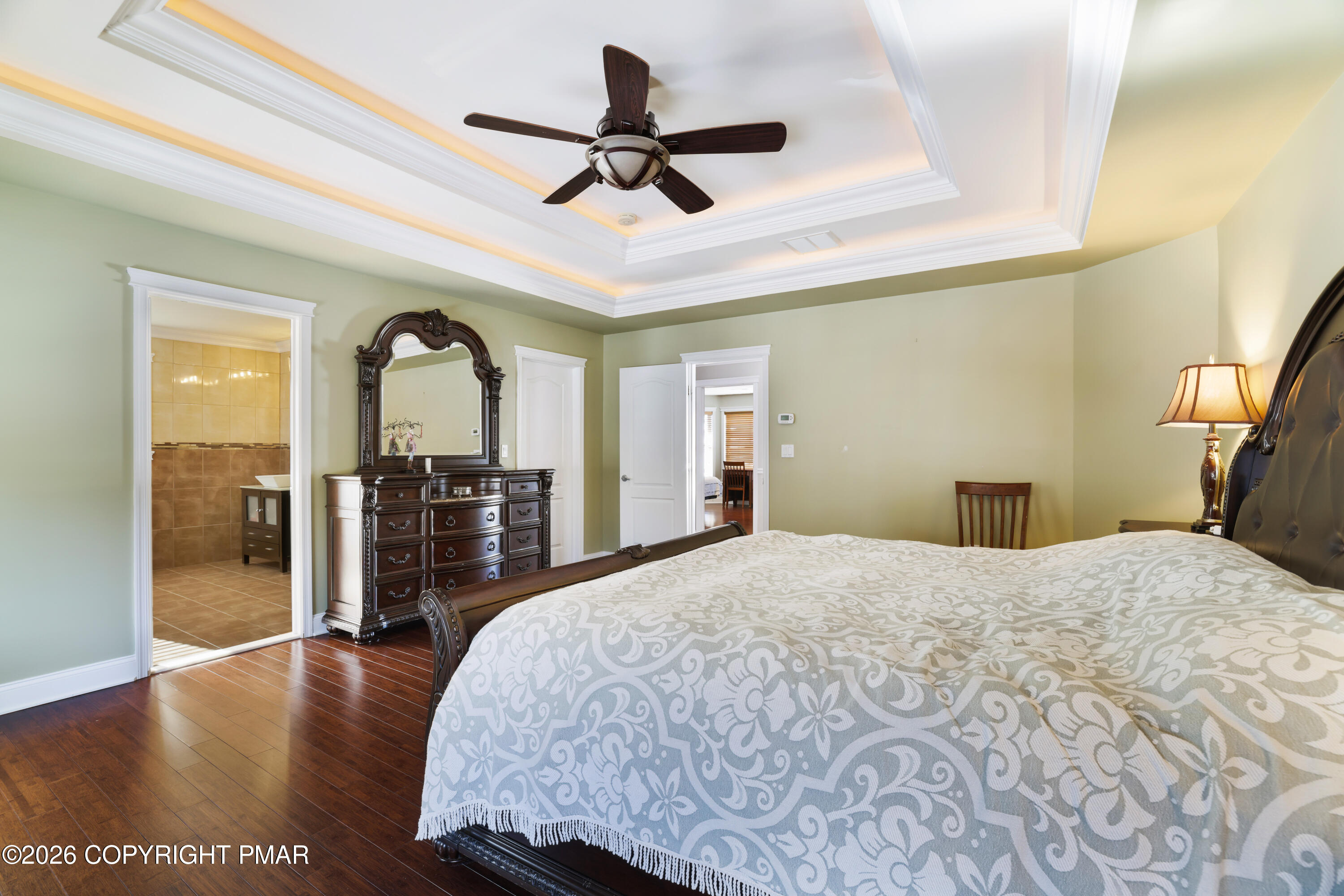 117 Fernwood Road Bushkill, PA 18324 - Photo 33 of 65 a bedroom with a large bed and a chandelier