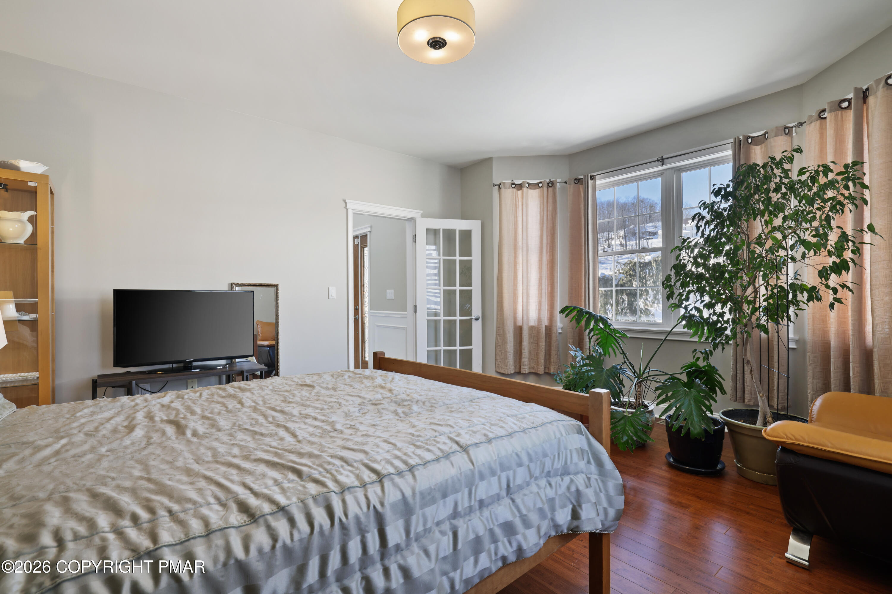 117 Fernwood Road Bushkill, PA 18324 - Photo 37 of 65 a bedroom with a bed and a potted plant