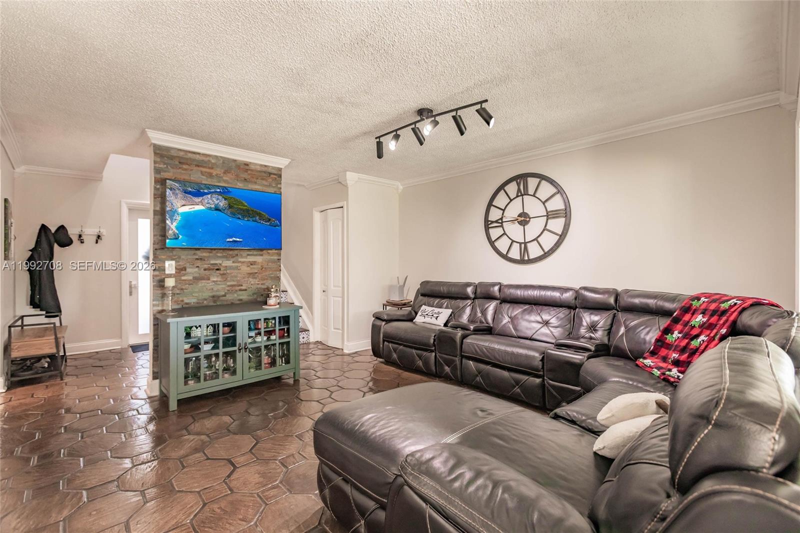 9404 Southwest 8th Terrace, Unit 9404 Miami, FL 33174 - Photo 14 of 41 a living room with furniture a couch and a wall painting