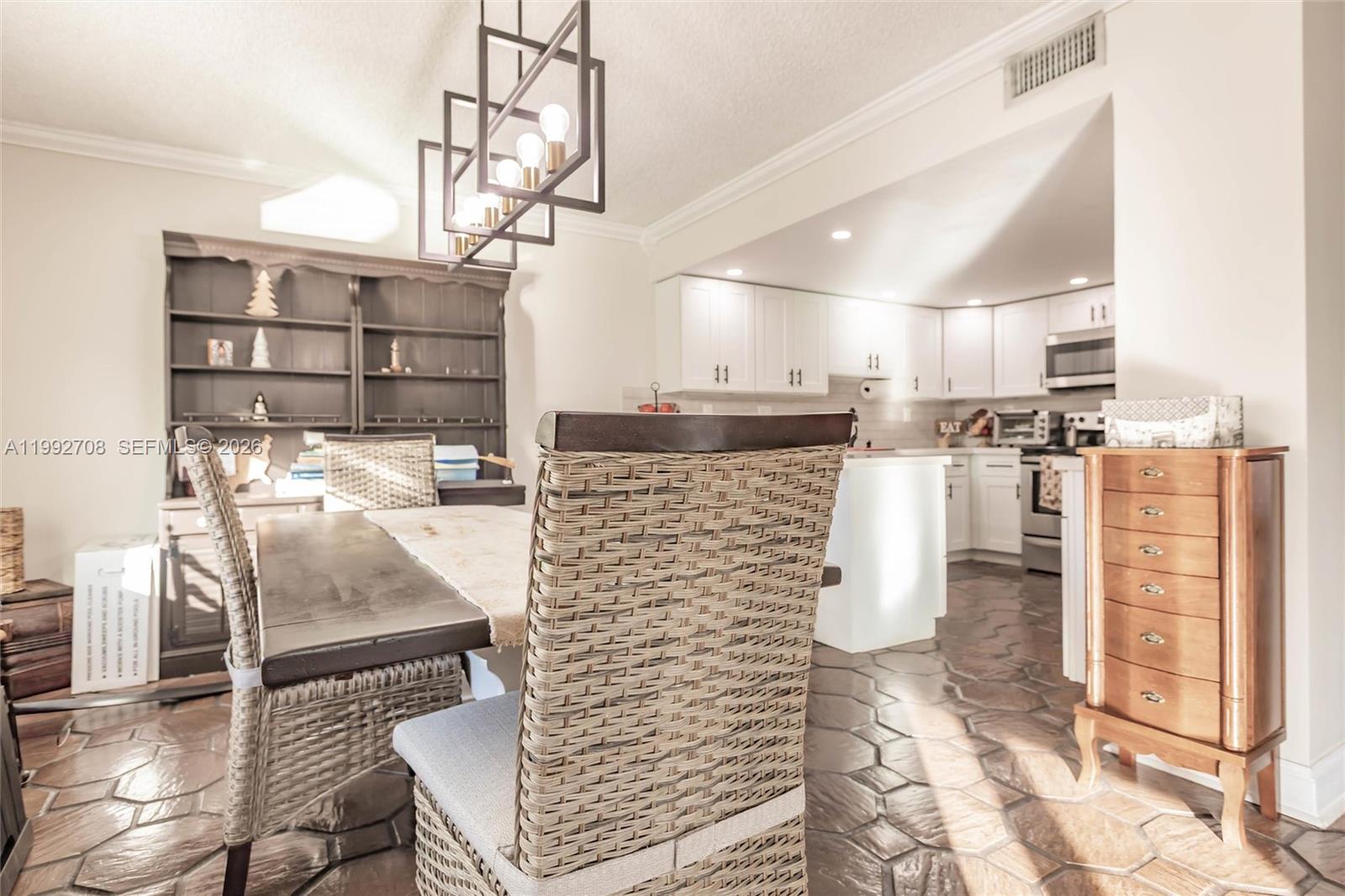 9404 Southwest 8th Terrace, Unit 9404 Miami, FL 33174 - Photo 18 of 41 a kitchen with stainless steel appliances kitchen island granite countertop a refrigerator and microwave