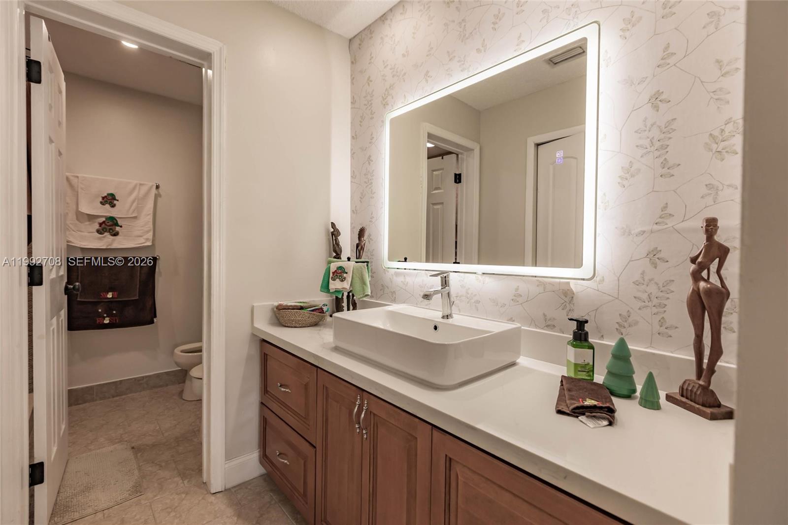 9404 Southwest 8th Terrace, Unit 9404 Miami, FL 33174 - Photo 31 of 41 a bathroom with a sink and a mirror