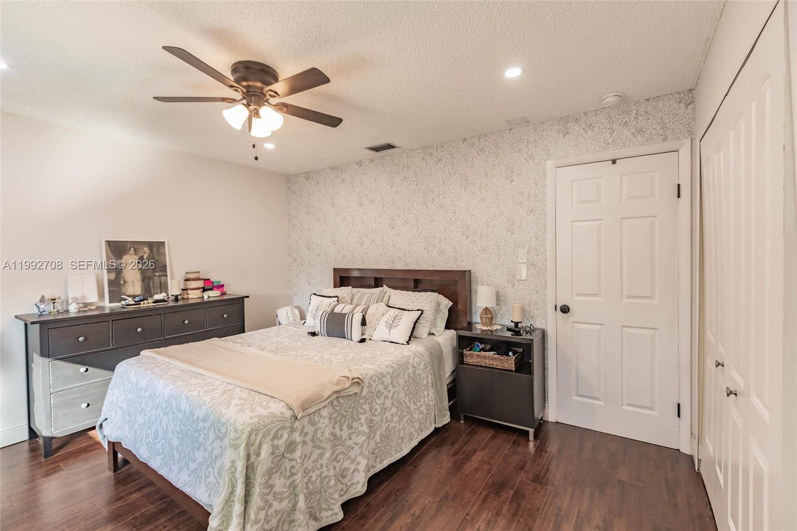 9404 Southwest 8th Terrace, Unit 9404 Miami, FL 33174 - Photo 40 of 41 a bedroom with a bed and a chandelier