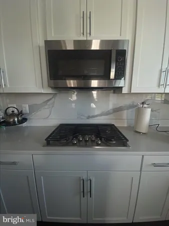 a kitchen with a stove and a microwave