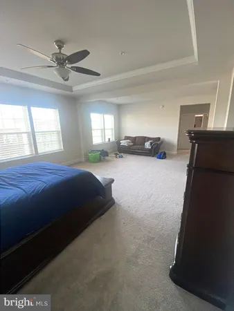 a spacious bedroom with a bed and window