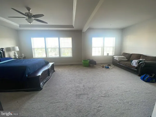 a spacious bedroom with a bed and a couch