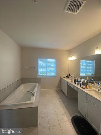 a large white kitchen with a large window