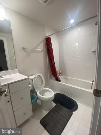 a bathroom with a sink a toilet and bathtub