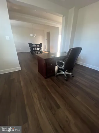 a view of a workspace with furniture and wooden floor