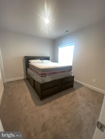 a spacious bedroom with a bed and a window