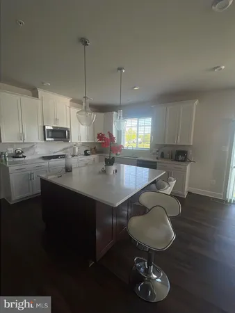 a kitchen with sink cabinets dining table and chairs
