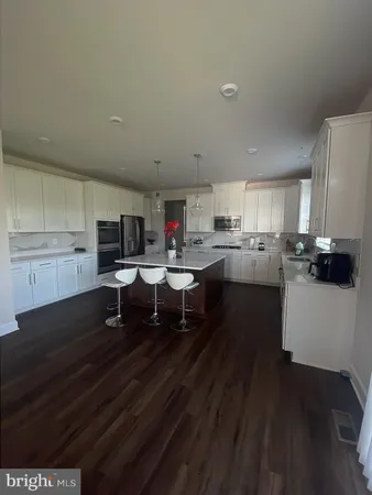 a open kitchen with cabinets table and chairs
