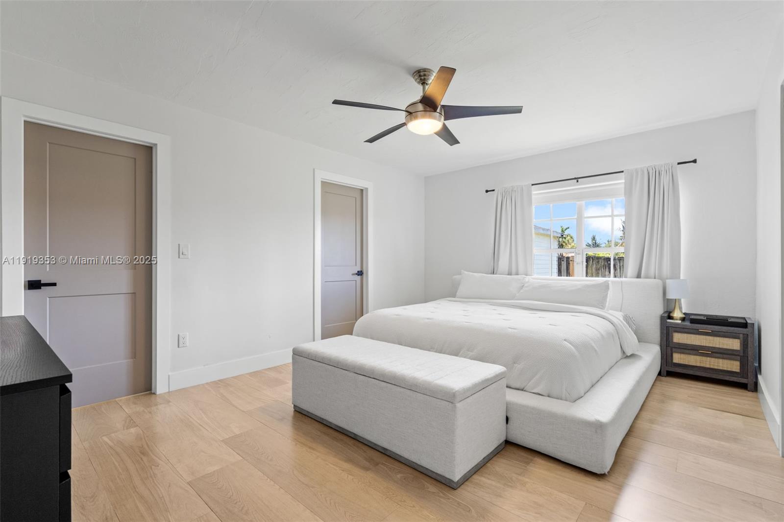 9920 Southwest 35th Terrace Miami, FL 33165 - Photo 14 of 32 a spacious bedroom with a large bed and a chandelier