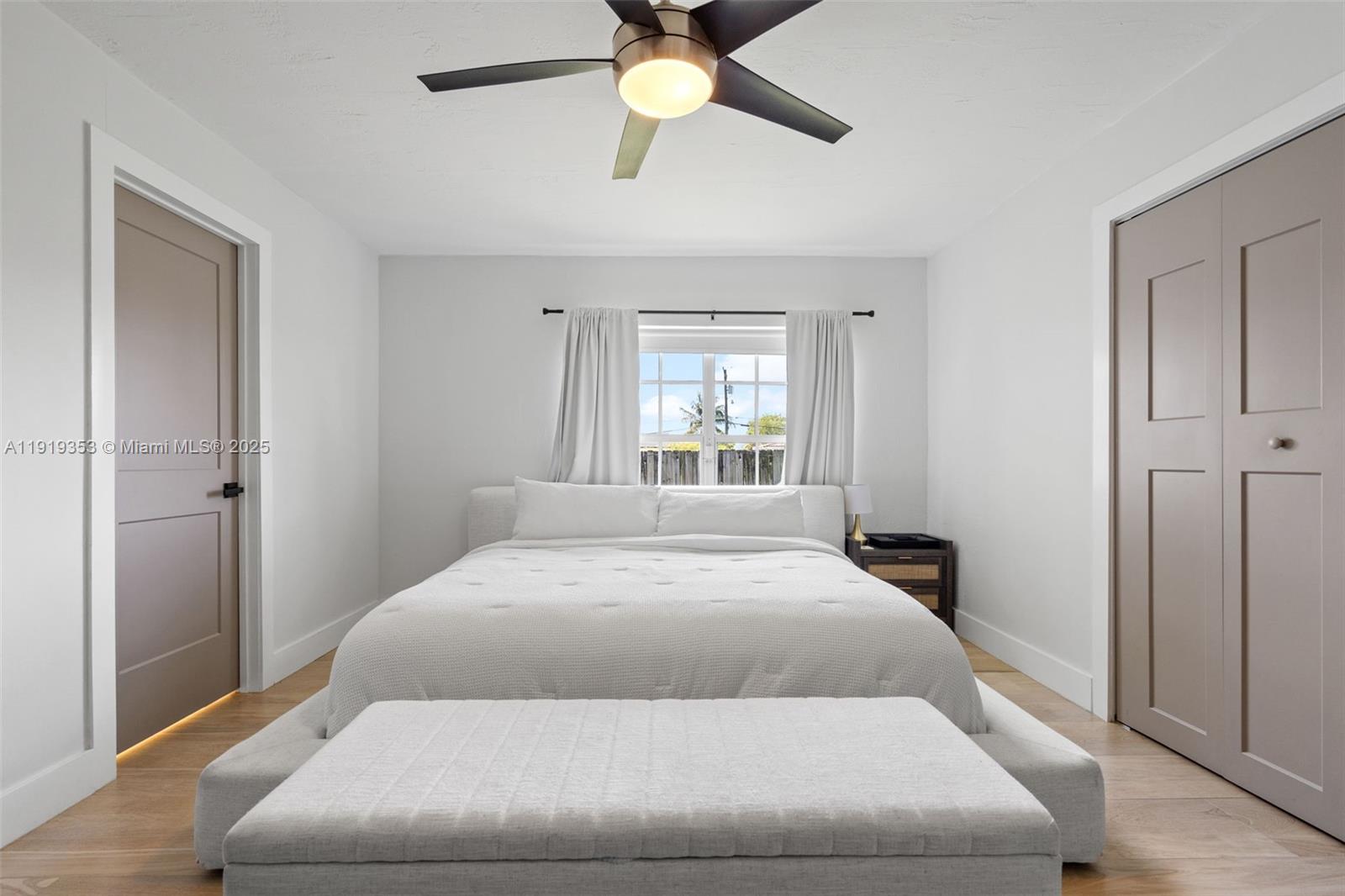 9920 Southwest 35th Terrace Miami, FL 33165 - Photo 15 of 32 a bedroom with a large bed and a chandelier fan