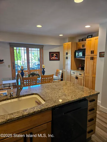 a view of a kitchen counter top space with furniture and flat screen tv