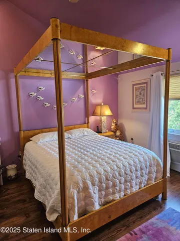 a bedroom with a bed and a mirror
