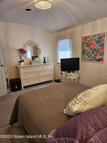 a bedroom with a bed and flat screen tv