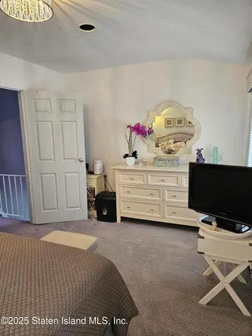 a spacious bedroom with a bed and a desk