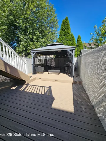 a view of a wooden deck with furniture