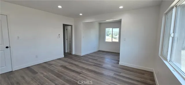 a view of room with window and wooden floor
